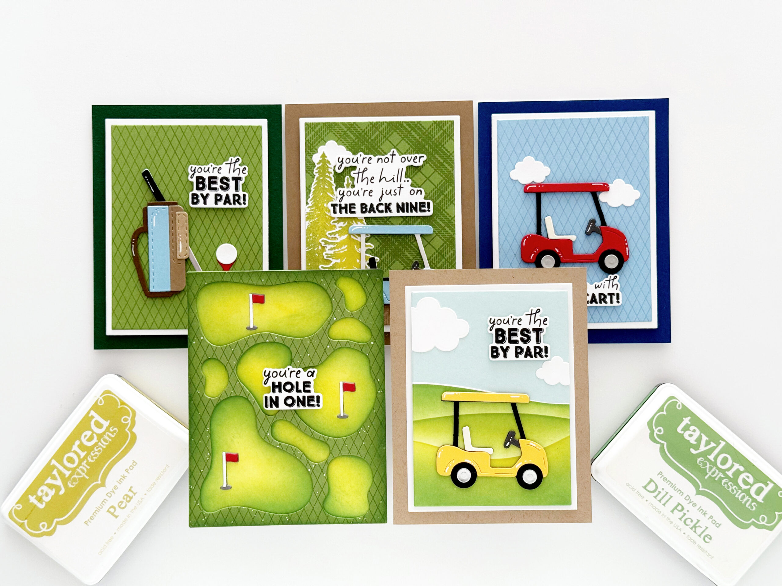 Group of colorful greeting cards with golf-themed puns on green, brown, and blue backgrounds (e.g., Best by Par, Hole in One).