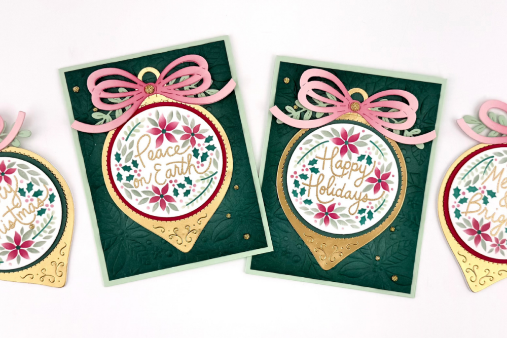 Two green holiday cards with pink bows, gold ornament shapes, and circular floral wreaths that say 'Peace on Earth' and 'Happy Holidays.'