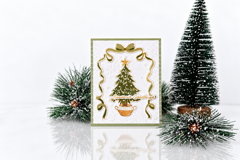 Handmade Christmas card featuring a green Christmas tree, gold accents, and a ribbon frame from Taylored Expressions' All Tied Up collection.